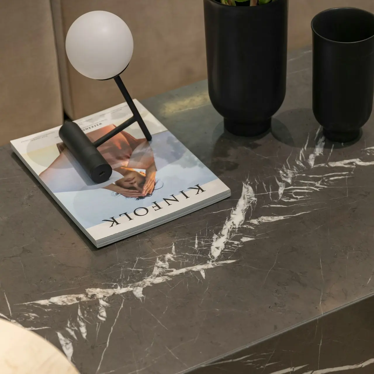 Modern marble tabletop surface finish with decorative accessories showcasing premium stone furniture finishes for interiors