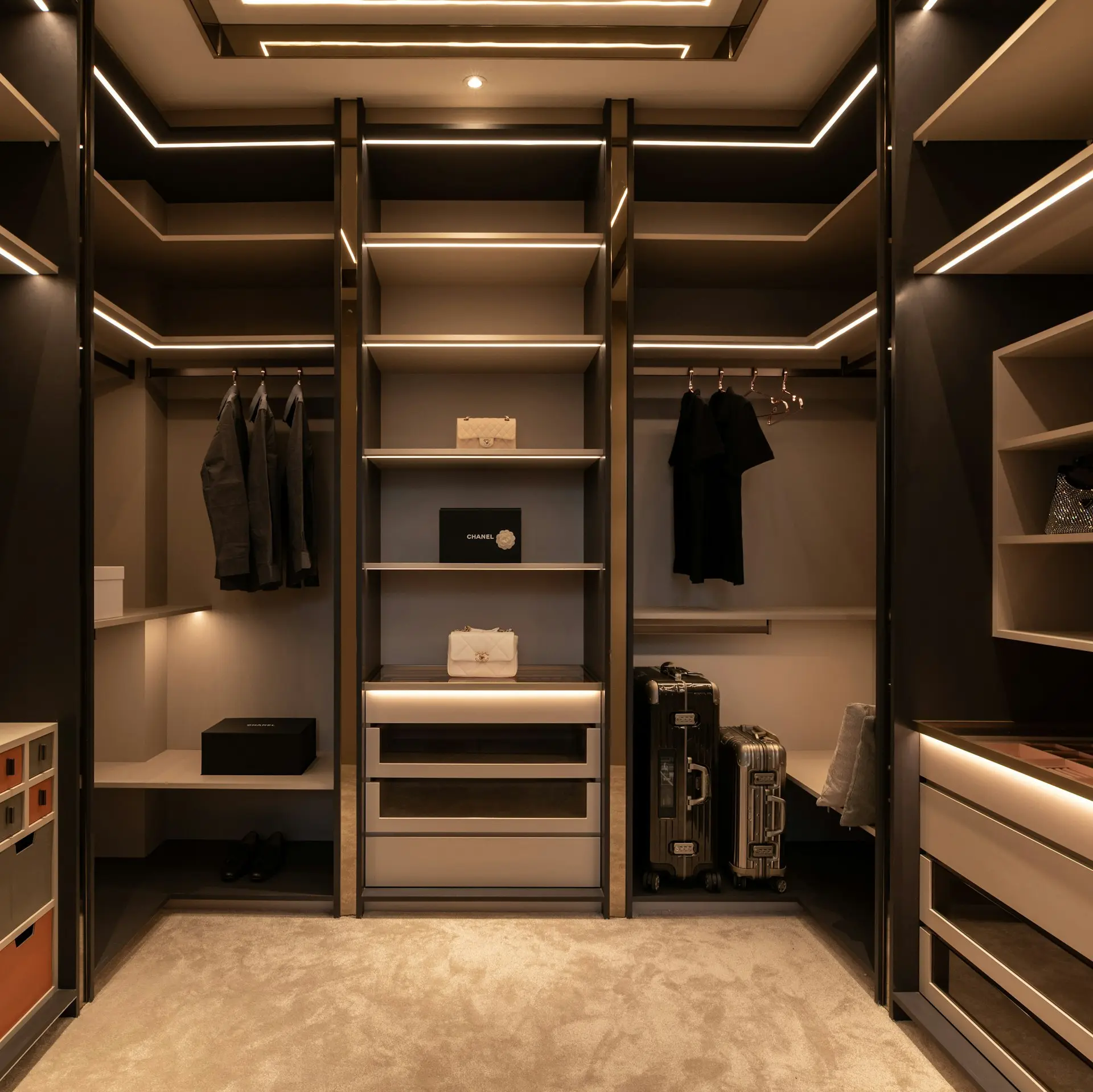 Luxury walk-in closet with built-in wardrobes and ambient lighting