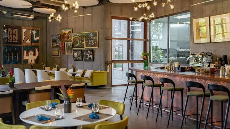 Hotel dining and lounge area with custom chairs, tables, and lighting