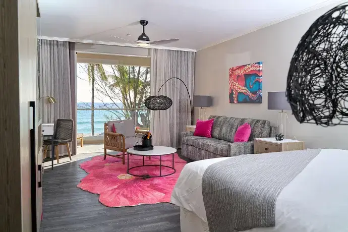 Hotel suite living area with bespoke sofa, lounge chairs, and coffee table