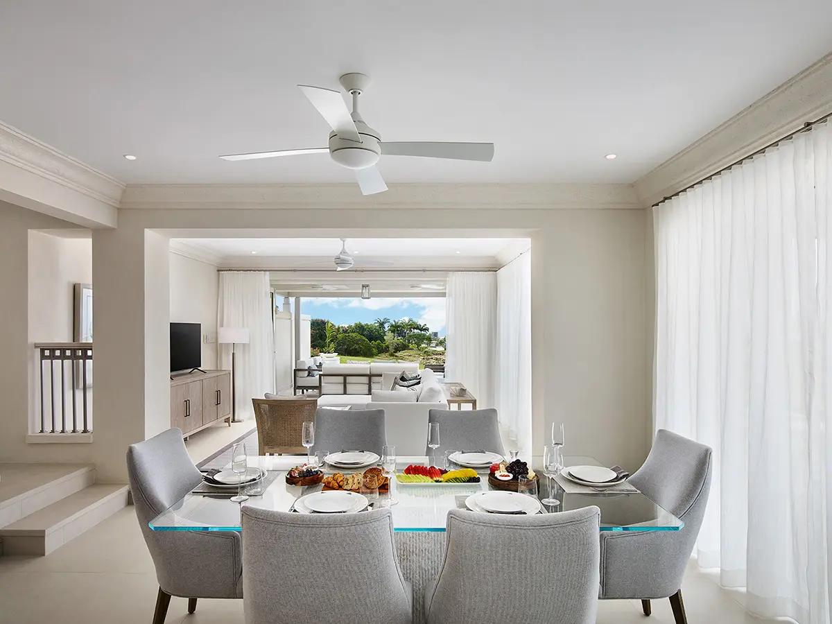 Hotel guestroom loose furniture including dining table, chairs, and seating area