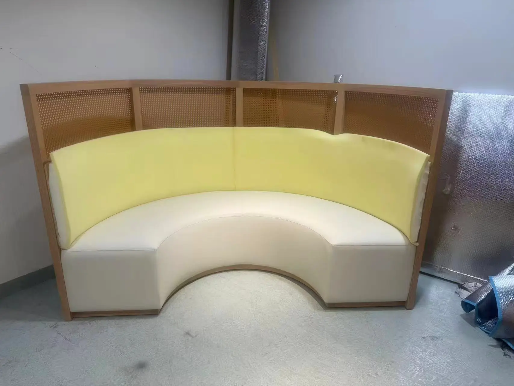 Custom curved sofa made in China with upholstered seating and wood frame detail