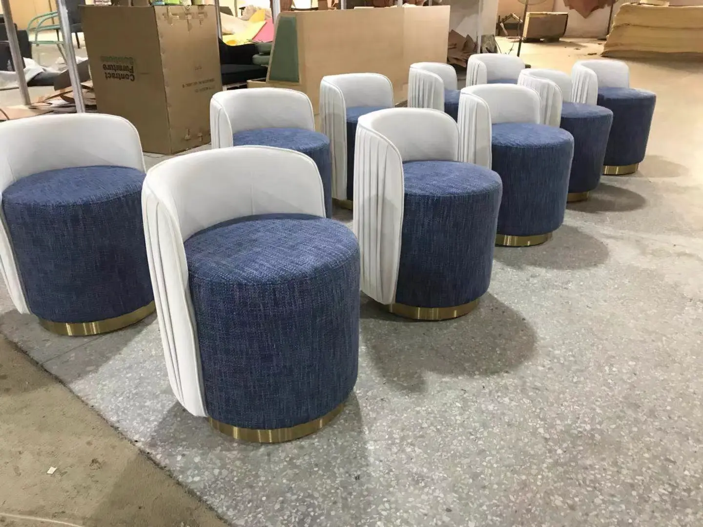 Modular upholstered chairs in production showing standardized design for hospitality furniture