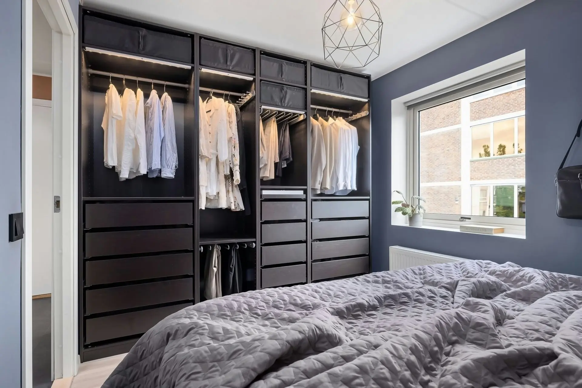 Modern built-in wardrobe system with drawers and hanging storage showcasing residential architectural millwork