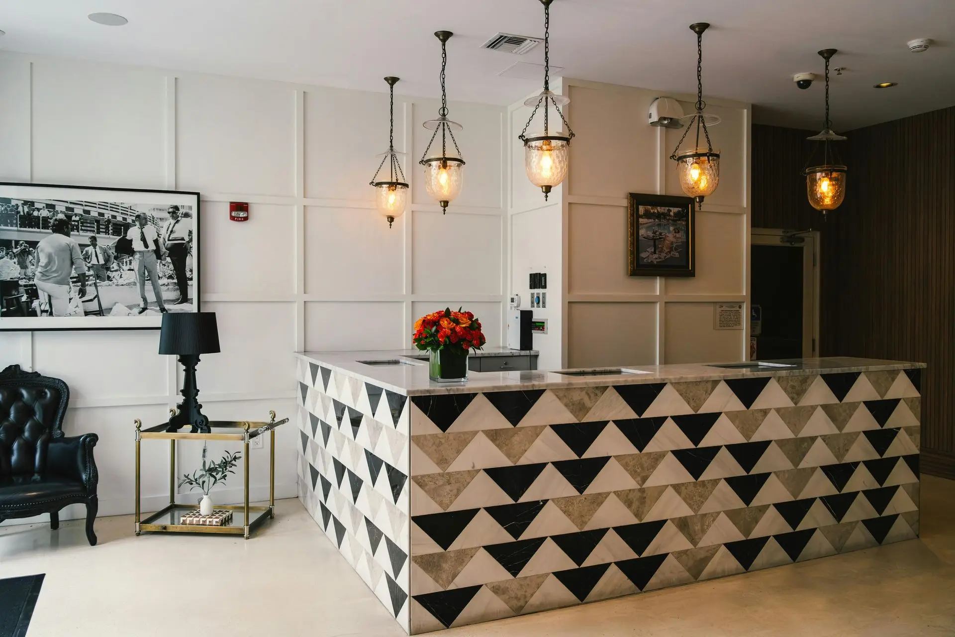 Custom Marble Reception Desk with Unique Geometric Design Custom marble reception desk with geometric design and warm lighting creating a strong first impression in a boutique lobby