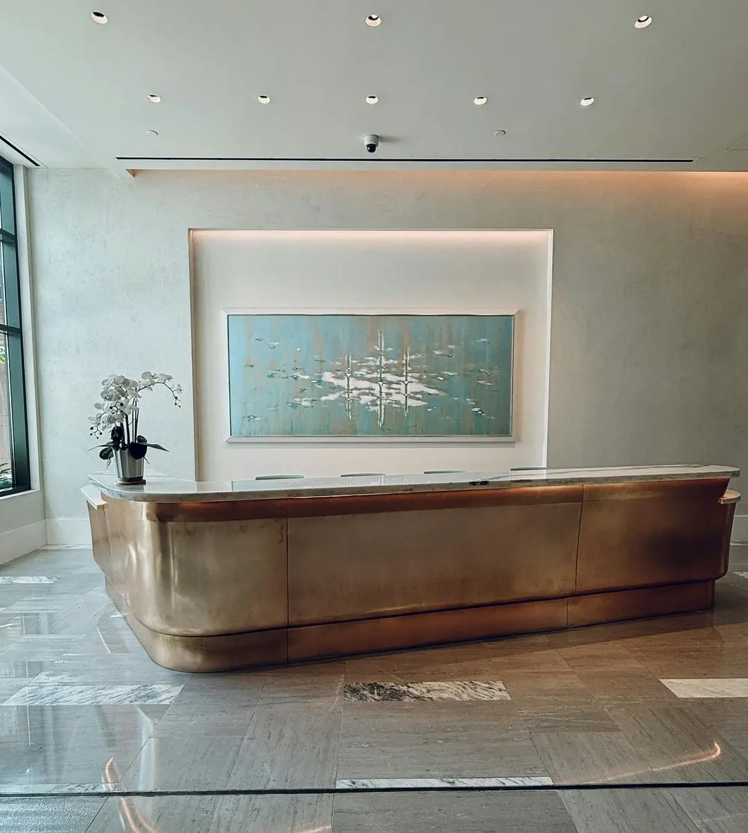 Reception Desk with Open Layout and Accessible Positioning Offset custom reception desk in a spacious lobby with open layout and smooth visitor flow