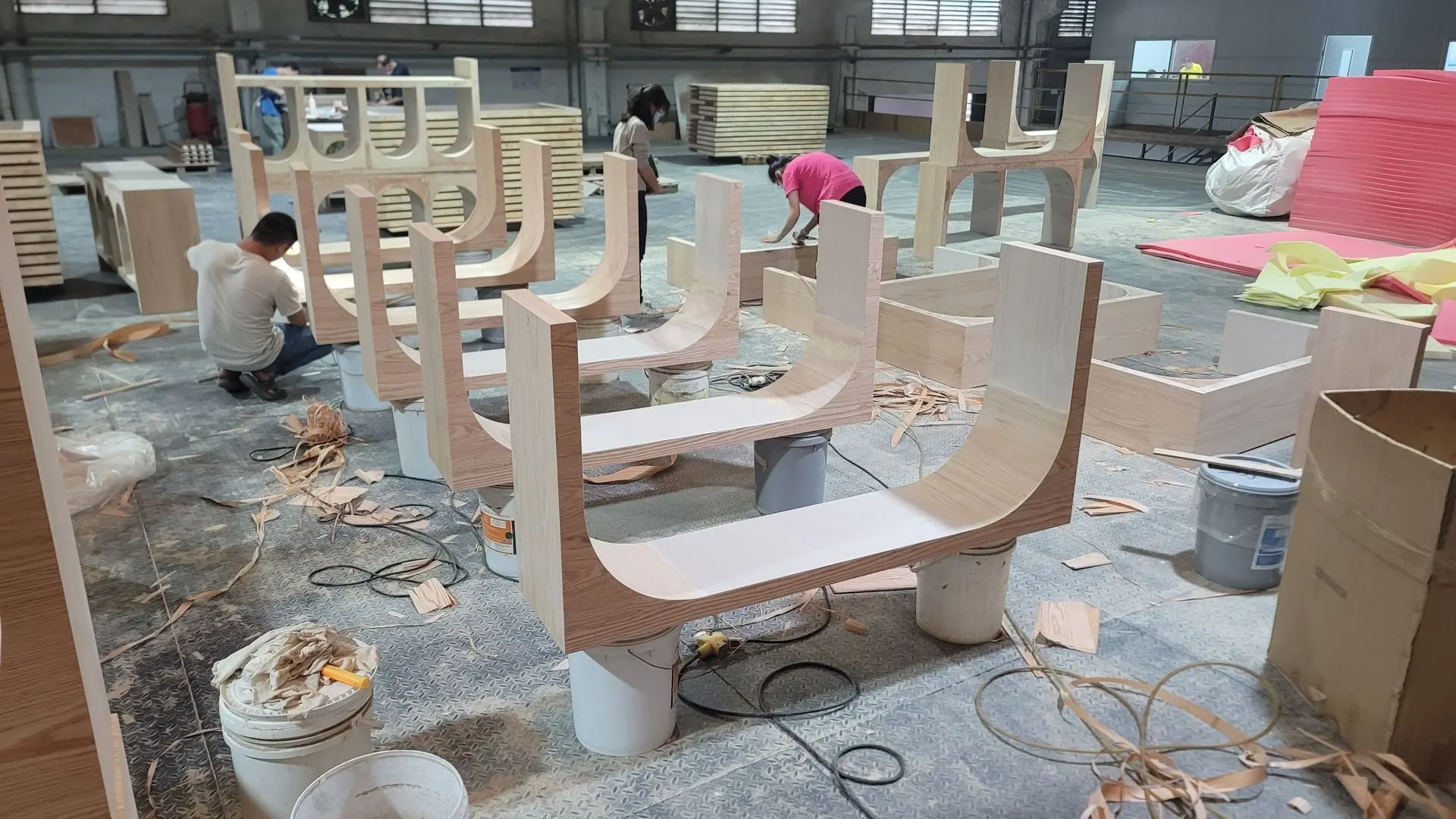 Contract furniture manufacturing process with wooden furniture frame construction in factory