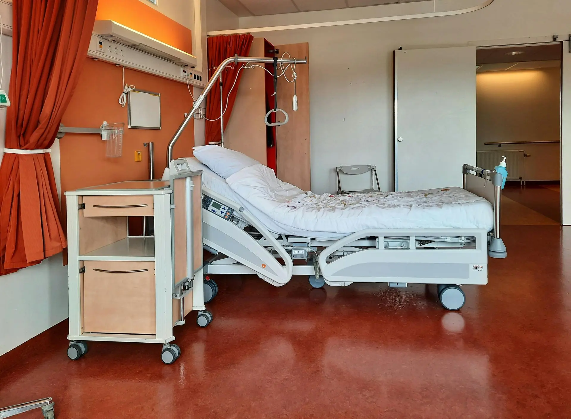Hospital healthcare room with hygienic contract furniture and medical-grade surfaces