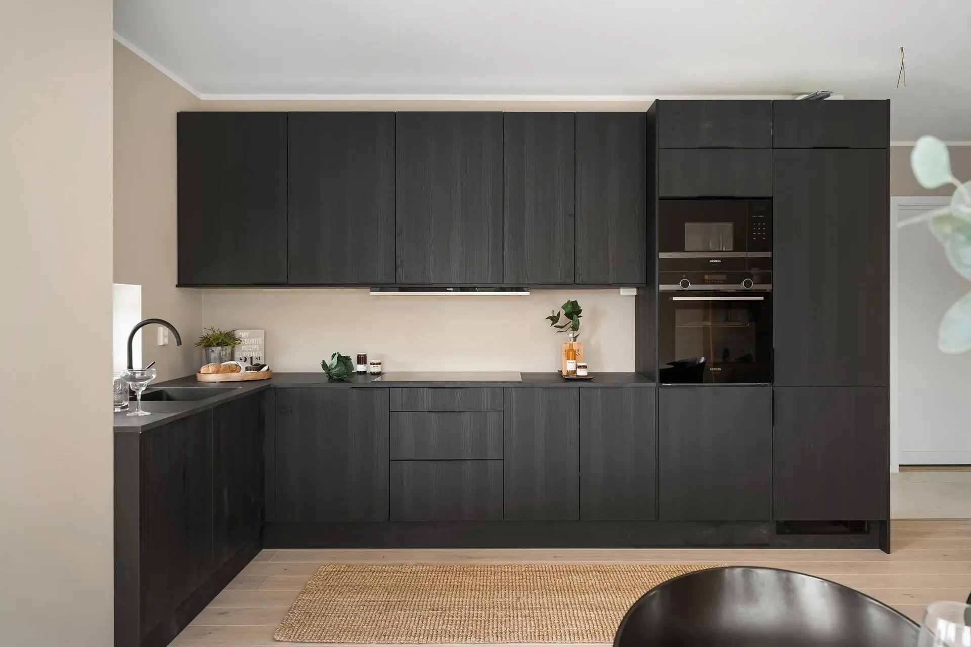 Modern Laminate Kitchen Cabinets and Millwork Materials Design Modern kitchen cabinetry featuring laminate millwork materials with black wood-look finish