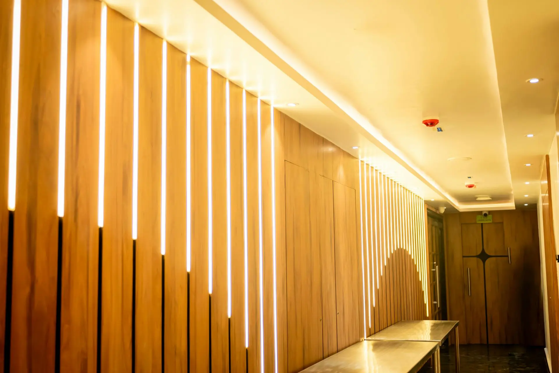 Luxury Hotel Corridor Featuring Fire-Rated Millwork and Wood Wall Panels Fire-rated millwork wall panels in luxury hospitality corridor interior