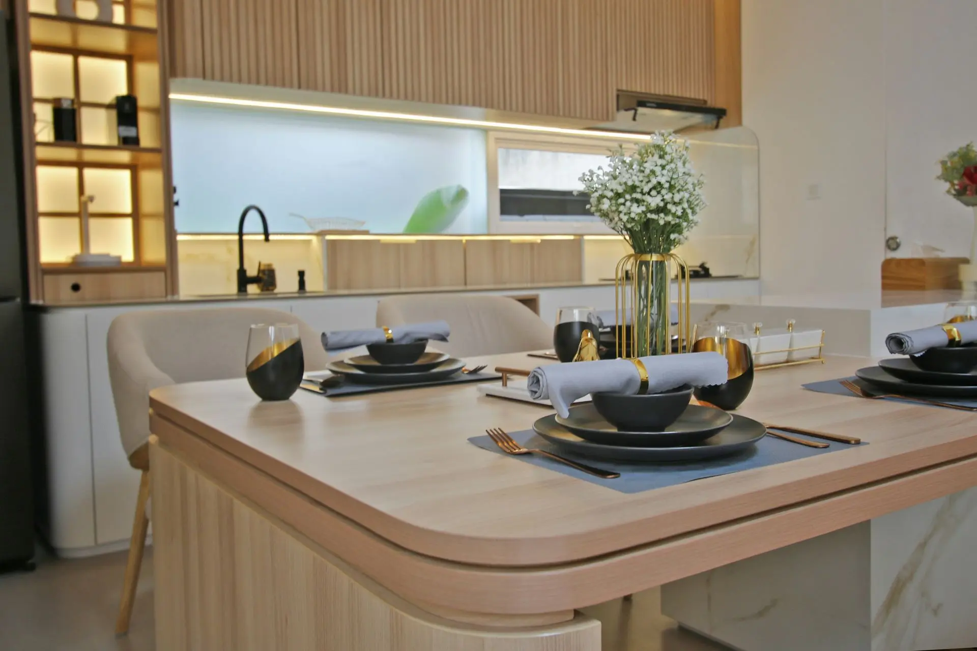 LED millwork lighting integrated into custom kitchen cabinetry and dining space