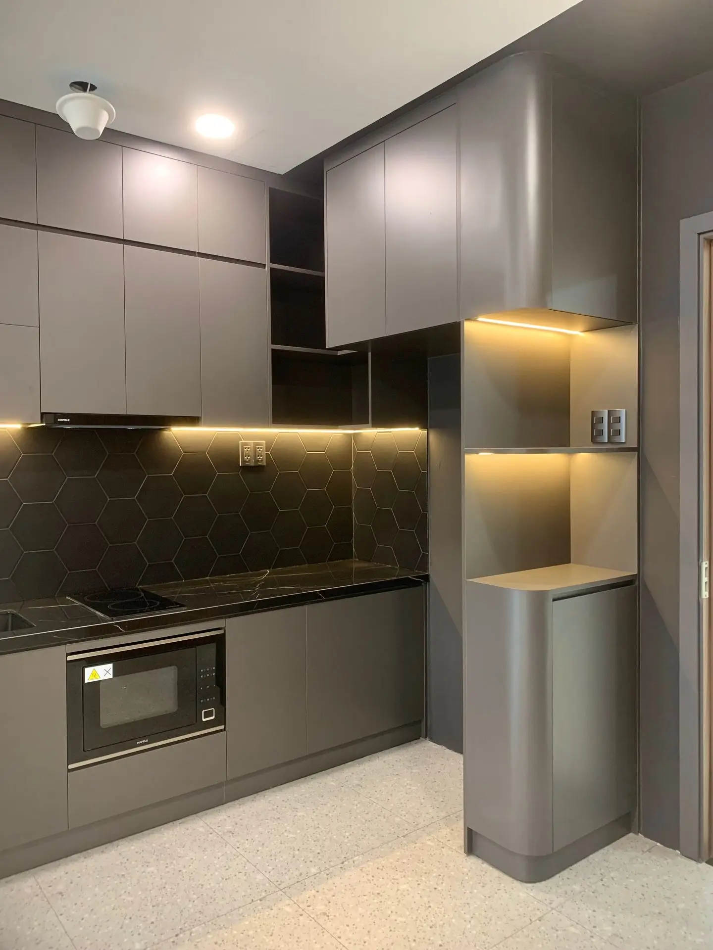 Modern kitchen with integrated LED strip lighting in custom cabinetry and display niches
