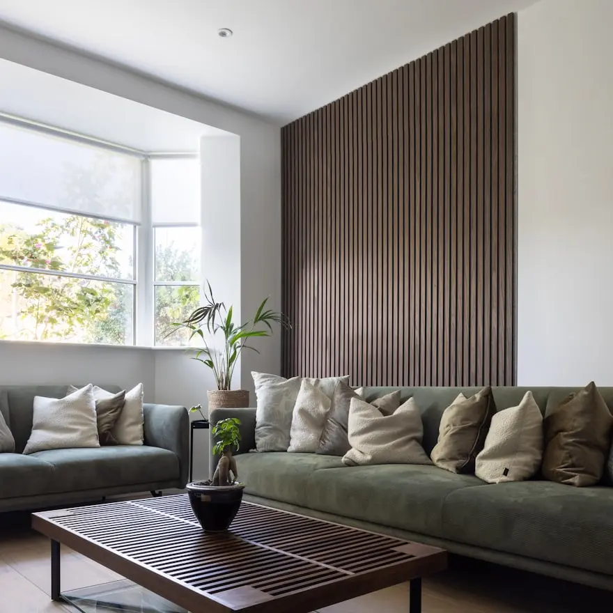 Modern slatted wood acoustic wall panels installed in a contemporary commercial interior to improve acoustics and interior aesthetics.