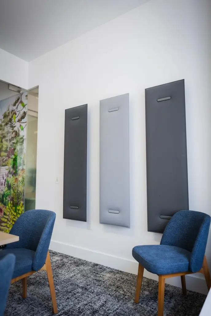 Fabric-wrapped acoustic wall panels installed in a modern office meeting room to improve sound absorption and reduce echo.