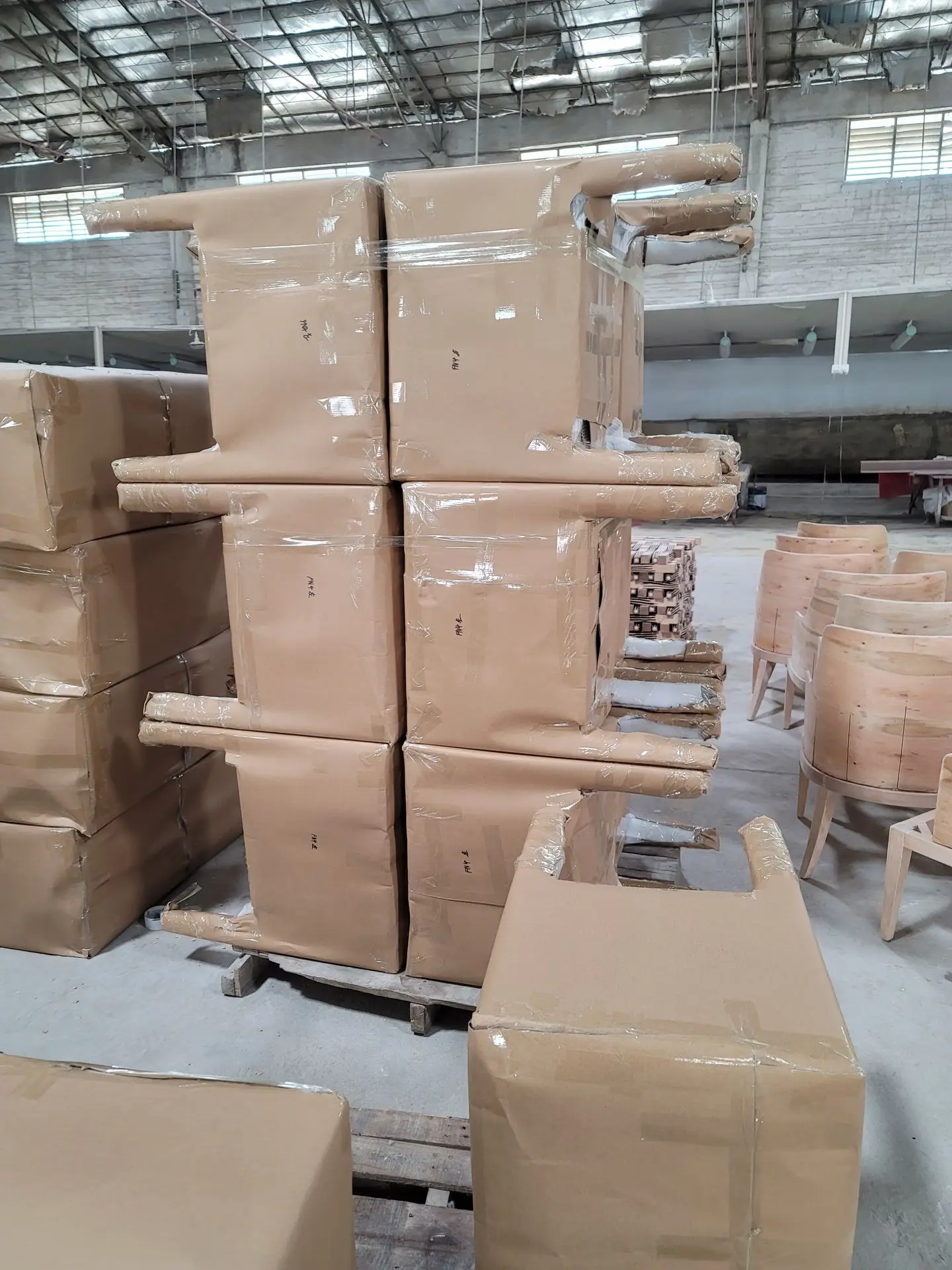Furniture Export Packaging for Bespoke Chairs During International Shipping Furniture export packaging with cardboard wrapping and stretch film protecting bespoke chairs for international shipping