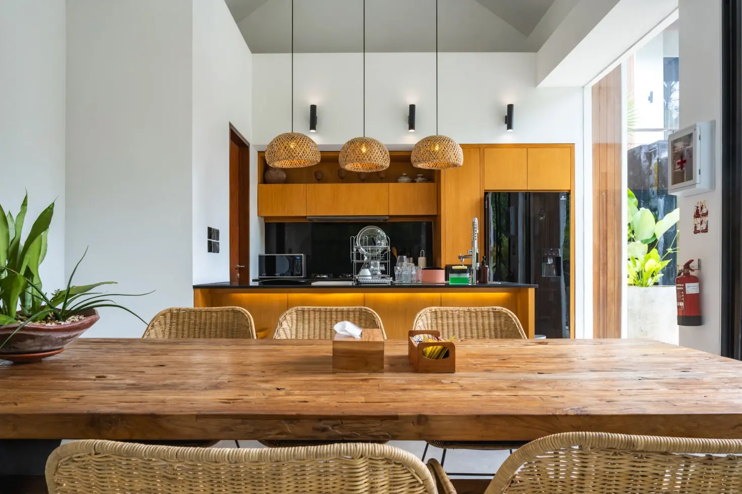 Contemporary home interior with custom wood cabinetry and handcrafted dining furniture showcasing Belosso's sustainable millwork expertise.