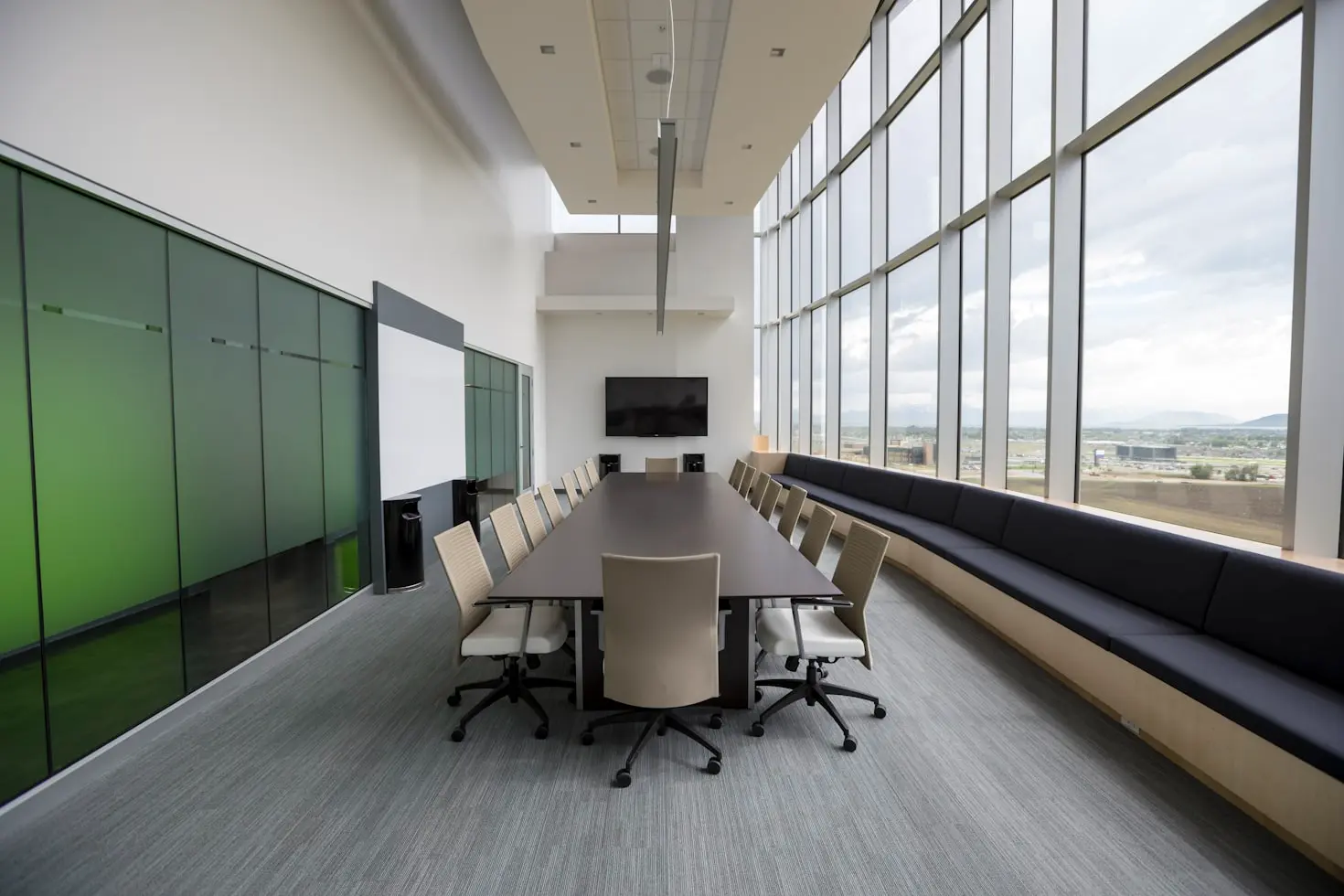 Modern corporate meeting room with conference table and built-in seating