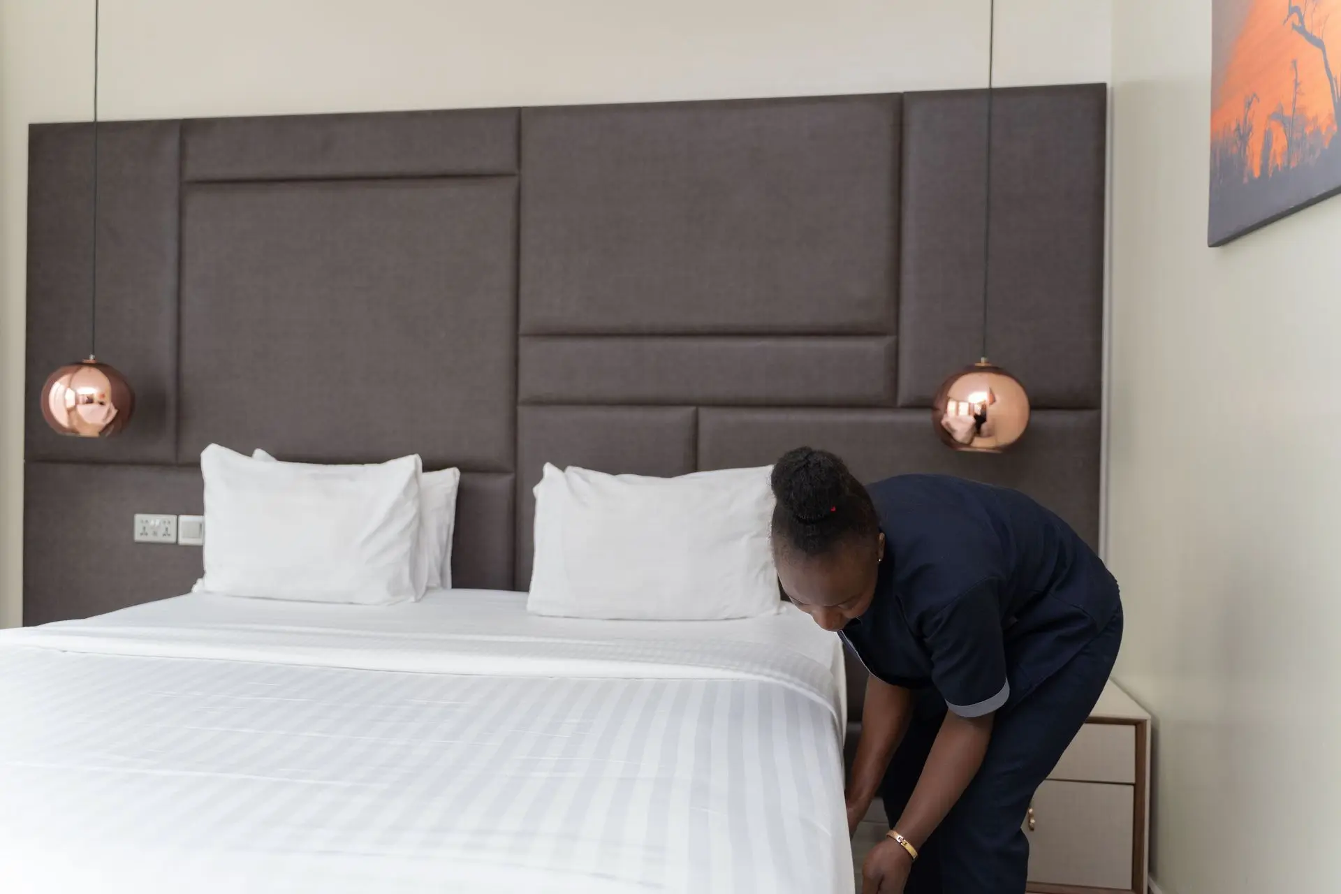 Hotel housekeeper cleaning a guest room with custom millwork