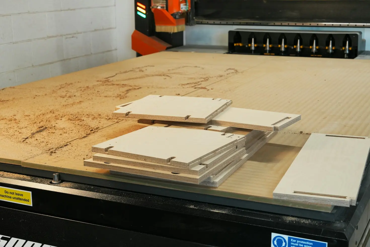 CNC router machining plywood panels for custom architectural millwork production