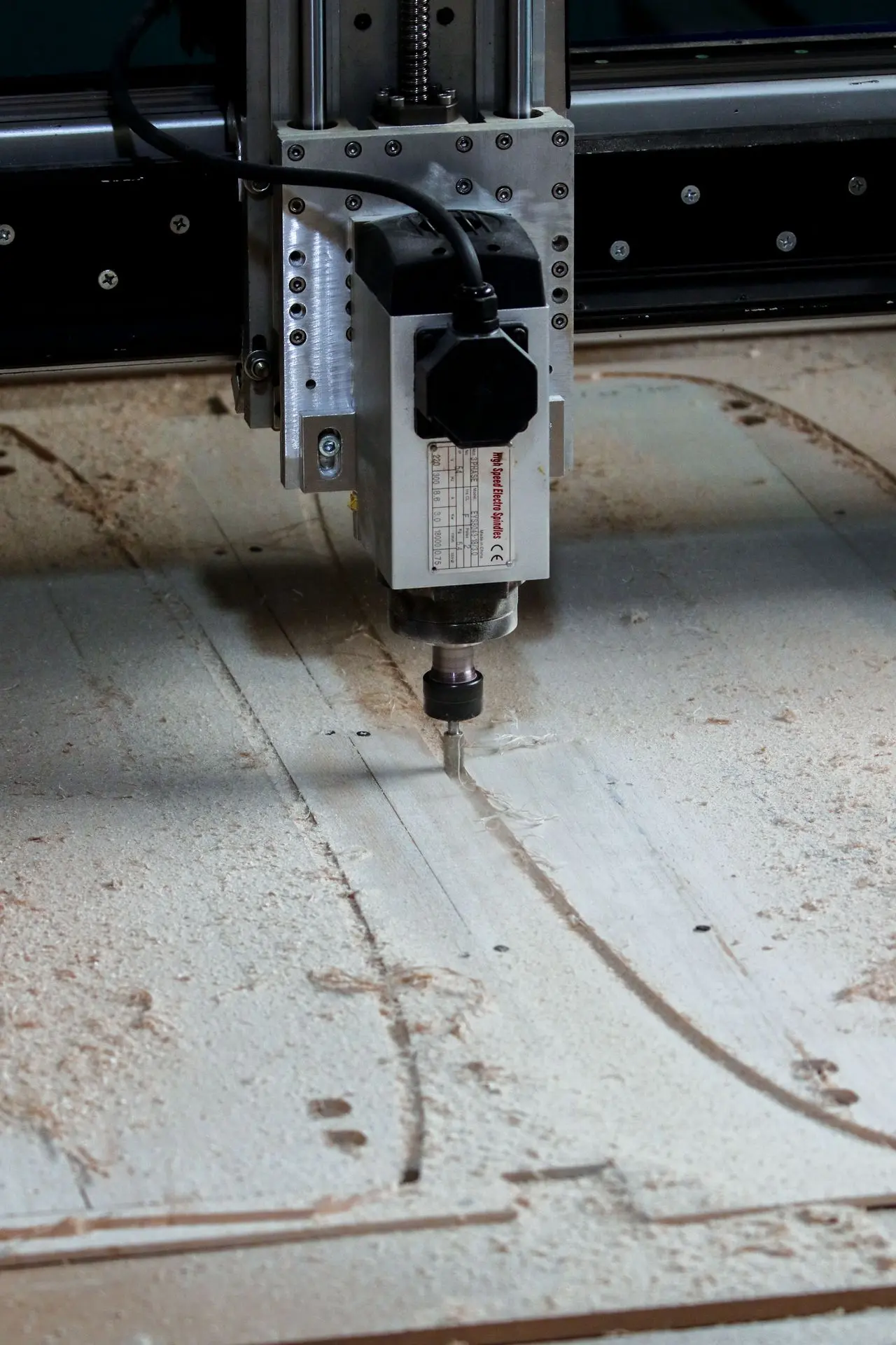 CNC router cutting a programmed path into a panel for precision millwork manufacturing