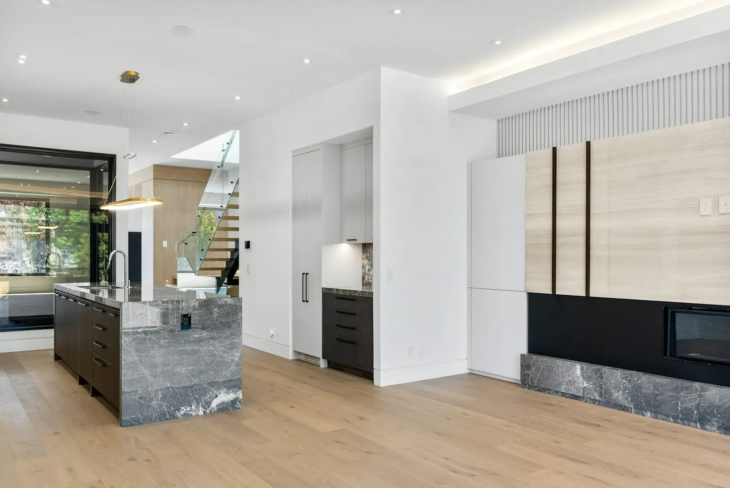 Modern interior featuring custom kitchen cabinetry, integrated storage, and architectural wood paneling